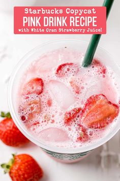 a pink drink with strawberries in it