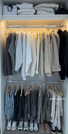 an organized closet with clothes and shoes