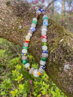 This 17.25 inch necklace is made with lampwork beads in the Norse style. The beads are made of COE 104 glass and the patterns on the beads are based on beads from the Norse and Anglo Saxon world. The glow beads are made with glow powder and give off a green, aqua, or blue glow when charged with light. The piece is strung on stainless steel wire and finished with stainless steel findings and a stainless steel lobster claw clasp. Many of the beads are made of COE 104 soft glass.  Green glows the b Multicolor Recycled Glass Beaded Jewelry, Multicolor Recycled Glass Bead Jewelry, Gift Recycled Glass Round Beads, Gift Recycled Glass Beads, Recycled Glass Beaded Necklaces As Gifts, Recycled Glass Beaded Necklaces For Gifts, Recycled Glass Beaded Necklaces With Round Beads As Gift, Recycled Glass Beaded Necklace With Round Beads As Gift, Multicolor Recycled Glass Jewelry With Large Beads