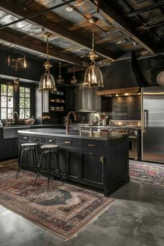 a large kitchen with black cabinets and an island in the middle, surrounded by gold pendant lights