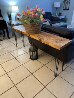 a wooden table with flowers on it in a living room