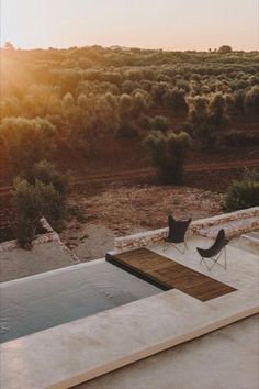 an outdoor swimming pool in the middle of a field