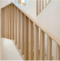 the stairs are made of wood and have handrails