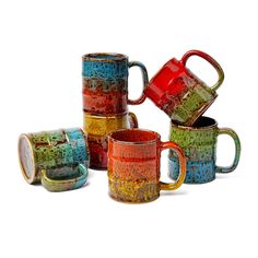 five different colored coffee mugs stacked on top of each other with one cup in the middle