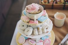 a three tiered cake stand with donuts, cookies and cupcakes on it