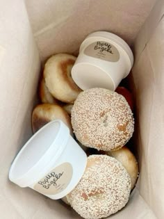 there are many donuts in the box and one has a coffee cup on it