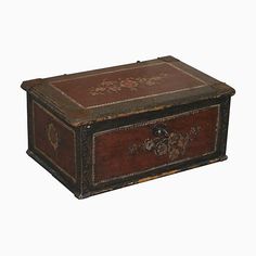 an old wooden box with decorative carvings on the lid and sides, sitting against a white background