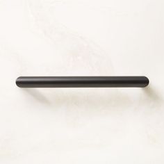 a black handle on a white wall