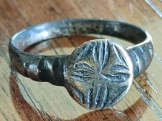 Ancient, Late Roman Carved Primrose bronze flower ring. Size 9.5, the Primrose bloomed first in Spring and represented New Life.  The primrose signified new life as it was the first plant to bloom in the spring. The design decorated many Roman mosaics and early Eastern Byzantine frescos. The design continued into early Christian motifs. This size 9.5 band has an ancient restored carved top with a 12mm diameter.  At the lowest point of the ring at the on the bottom, the bronze ring is 2.7mm at th Roman Mosaics, Roman Ring, Coin Store, Roman Mosaic, Modern Tools, Coin Shop, Bronze Ring, Coin Pendant, Jewelry Business