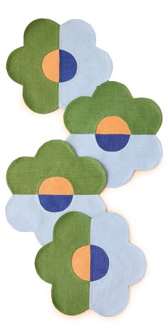 three pieces of paper with different shapes and colors on them, one in the shape of an egg