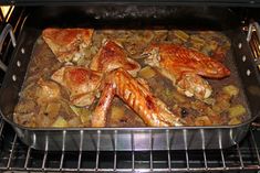 chicken and potatoes cooking in an oven