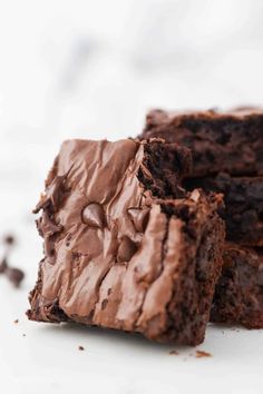 two pieces of chocolate brownie sitting on top of each other