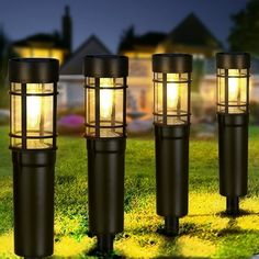 three lights that are sitting in the grass