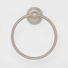 a round metal towel ring on a white wall