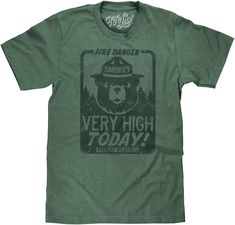 PRICES MAY VARY. Your New Favorite Smokey Bear Shirt: Show off your love for our national parks with the iconic Smokey Bear mascot and "Fire Danger Very High Today" text - distressed and printed on the softest Dark Green Heather tee we could find. Easy Care Tees: This Smokey Bear design is licensed and screen-printed on a soft, poly-cotton t-shirt that goes from the washing machine to the dryer without losing shape, shrinking or fading. Graphic is intentionally distressed for a worn, vintage loo Smokey The Bear, Smokey Bear, Smokey The Bears, Retro Graphic Tees, Nature Shirts, Casual Night Out, Beautiful Park, Bear Shirt, Bear T Shirt