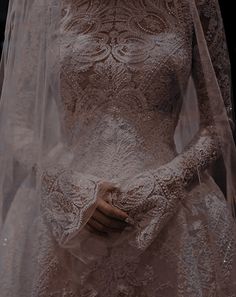 a woman wearing a wedding dress and veil