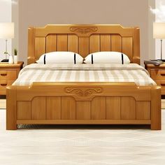 a wooden bed with white pillows and two lamps on either side of the headboard