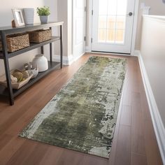 a large rug is on the floor in front of a white door and entryway