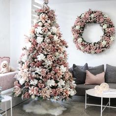 a living room decorated for christmas with wreaths on the wall and flowers hanging from the ceiling