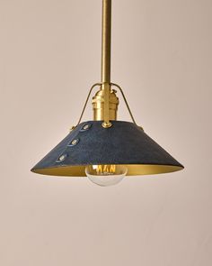 a blue and gold pendant light hanging from a ceiling