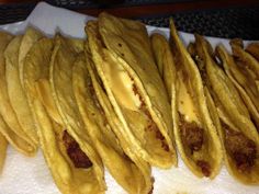 some tacos sitting on top of a white paper towel