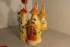 a ceramic figurine of a castle with a hot dog hanging from it's chimney