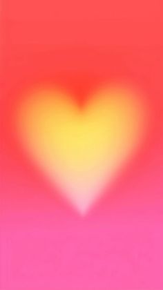 a blurry image of a heart in pink and yellow colors on a red background