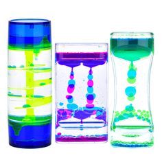 three different colored vases sitting next to each other on a white surface, one is filled with liquid