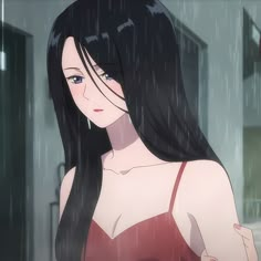 a woman with long black hair standing in the rain