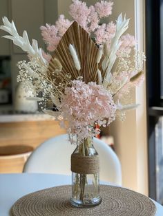 a vase filled with flowers sitting on top of a table