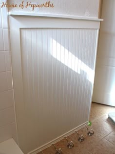 a white toilet sitting in a bathroom next to a shower