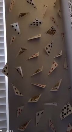 several pieces of playing cards are hanging on the wall