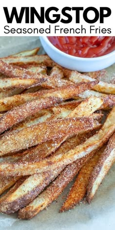 french fries with ketchup and seasoning on the side, ready to be eaten