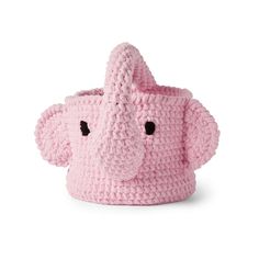 a pink crocheted elephant toy sitting on top of a white surface