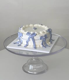 a blue and white cake sitting on top of a glass plate