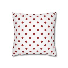 a white pillow with red polka dots on it