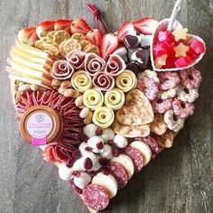 a heart shaped platter filled with different types of food