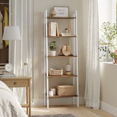 a bedroom with white walls and wooden shelves