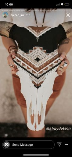 a person holding a cow skull in their hands