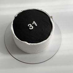 a black and white cake with the number thirteen on it