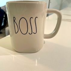 a white coffee mug with the word boss written on it