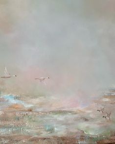 two white birds flying in the sky above some water and land, with pink clouds