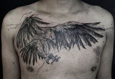 a man's chest with an eagle tattoo on it