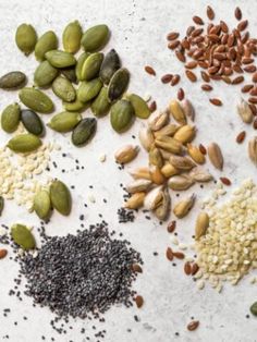 nuts, seeds and seeds on a white surface