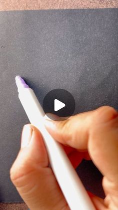 a person holding a white pen in their left hand