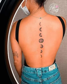 the back of a woman's neck with phases on her upper and lower back