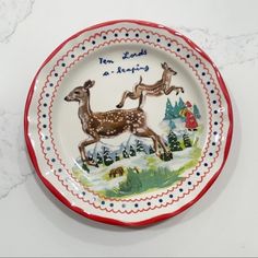 a ceramic plate with two deers on it