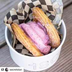 two doughnuts in a basket with pink ice cream