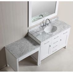 a white sink sitting under a mirror next to a counter