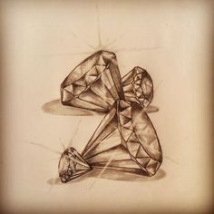 a pencil drawing of two diamonds on a piece of paper, one with a diamond cut in the middle